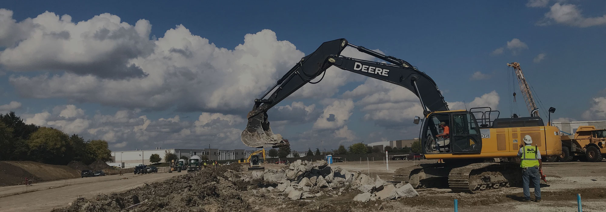 Excavator moving boulders